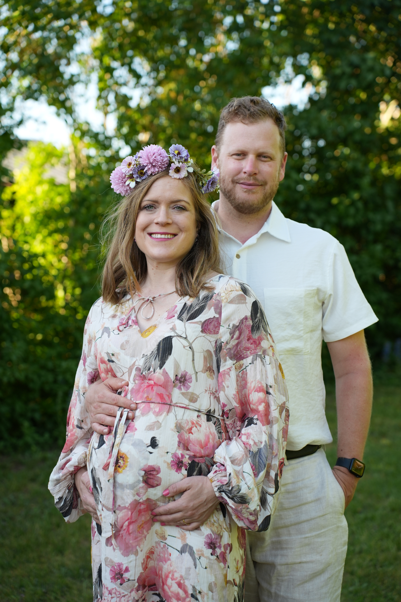 Amanda med blomsterkrans och Simon i sommargrönskan